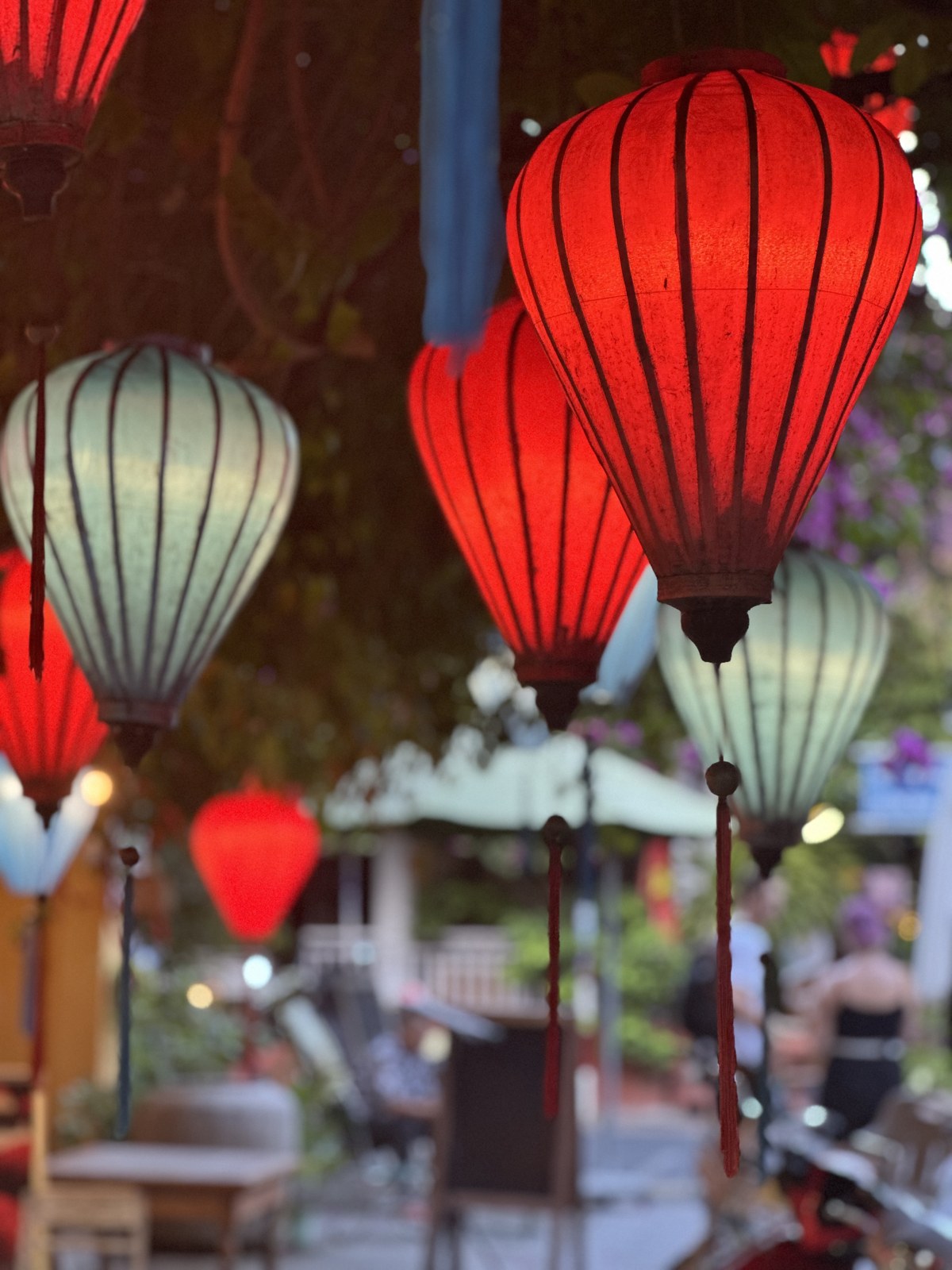 Red and pale silk lanterns hanging outside a Hội An shop